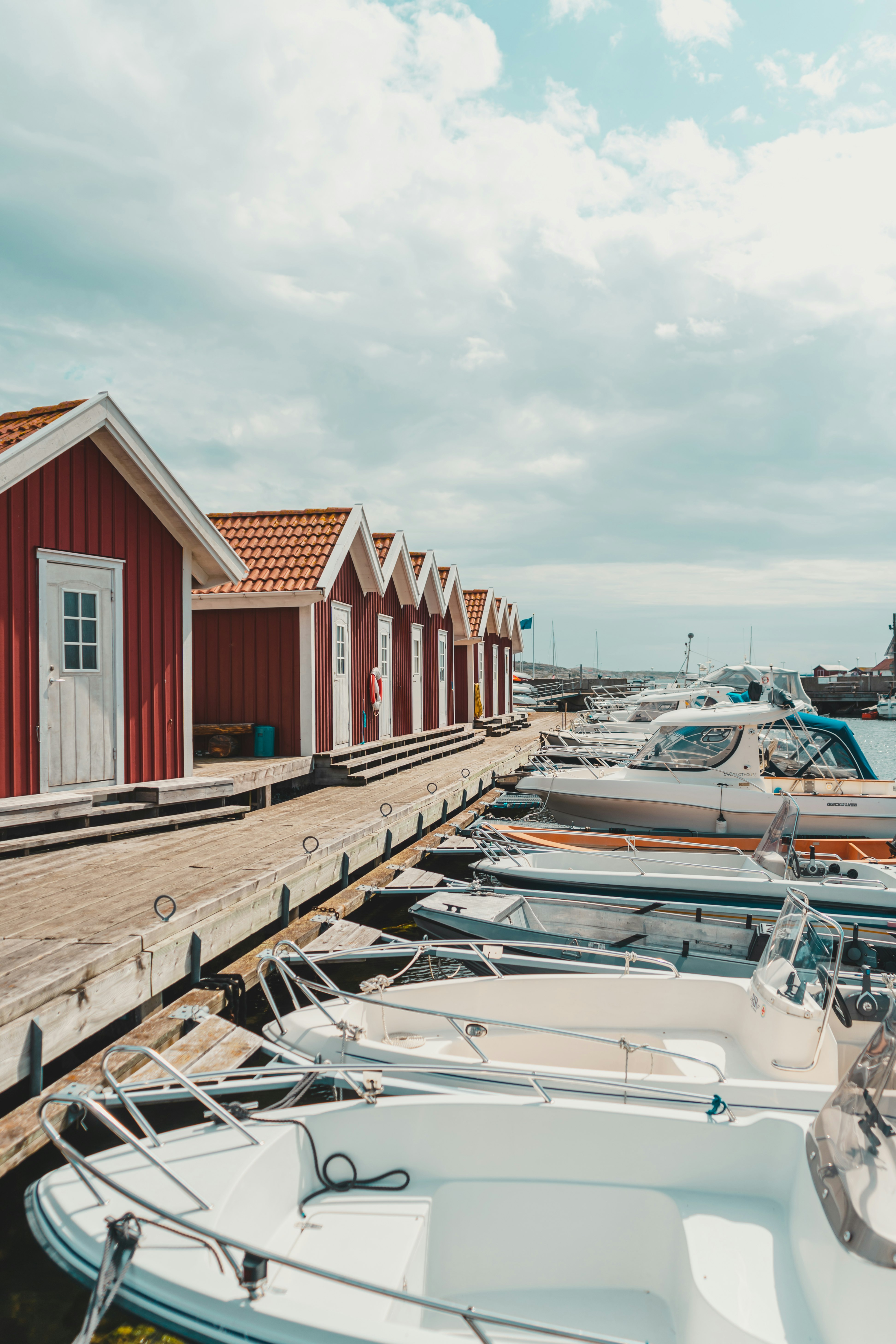 red and white wooden houses near body of water during daytime